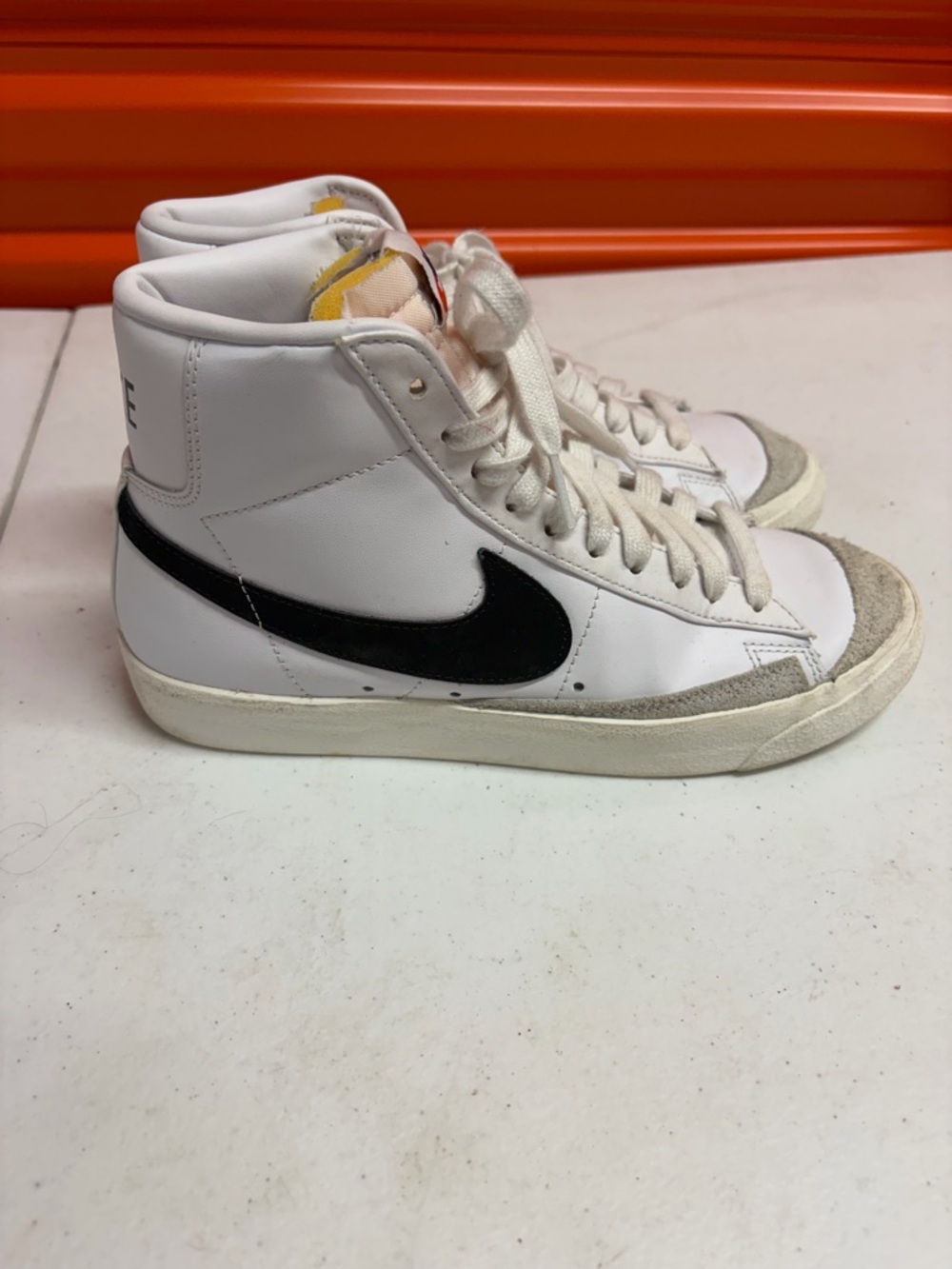 Nike White High-Top Sneakers with Black Swoosh and Gray Suede Toe